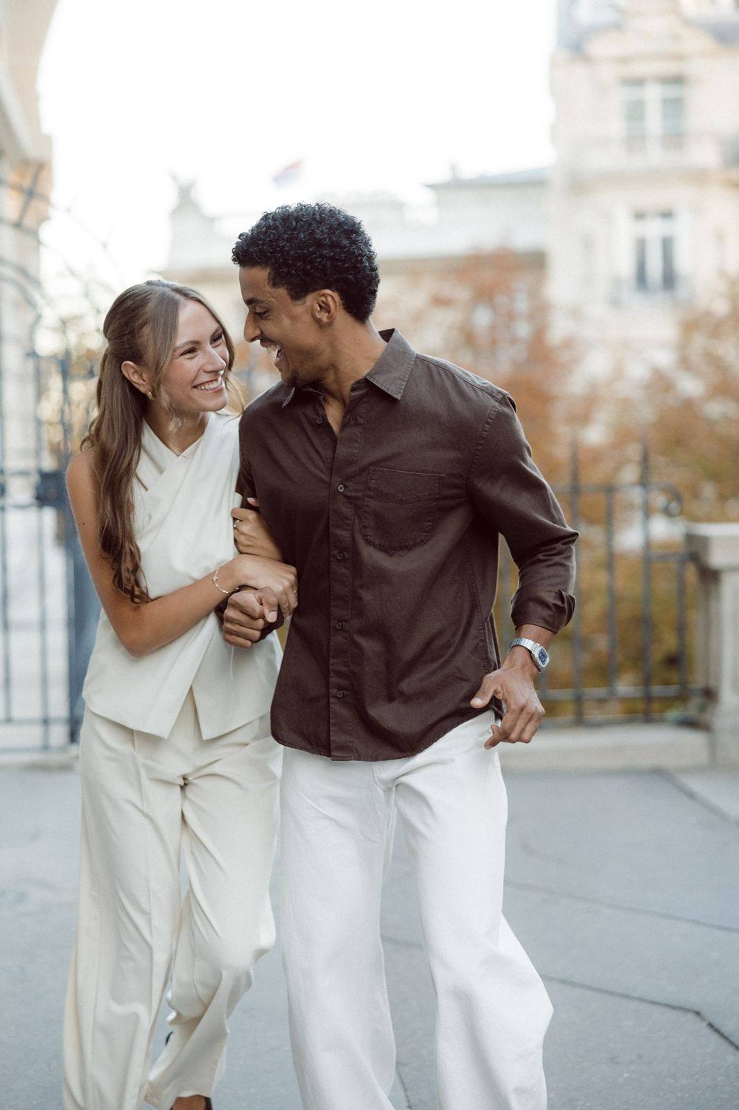 Couple walking arm in arm in Paris