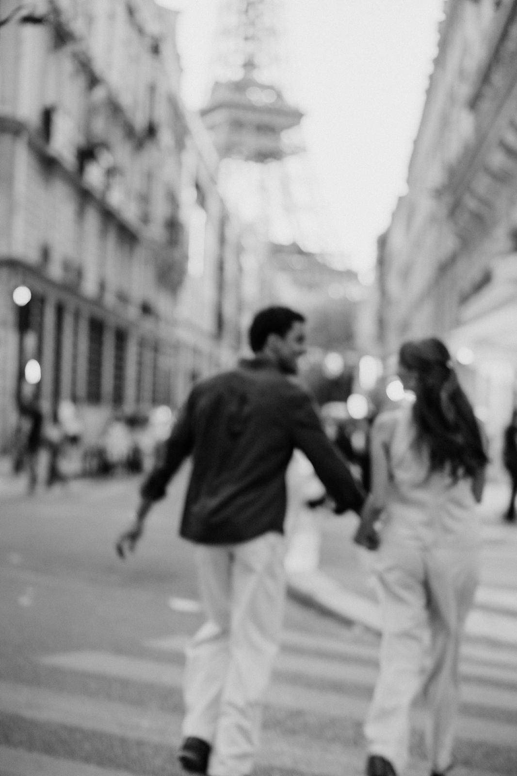 Couple walking hand in hand in Paris, black and white