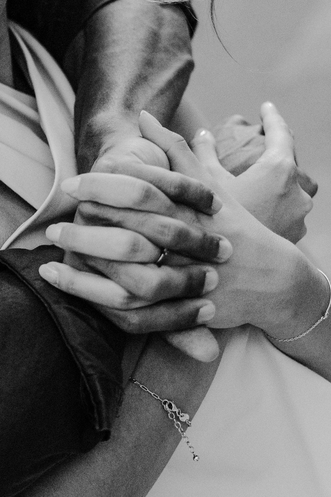 Intertwined hands, black and white