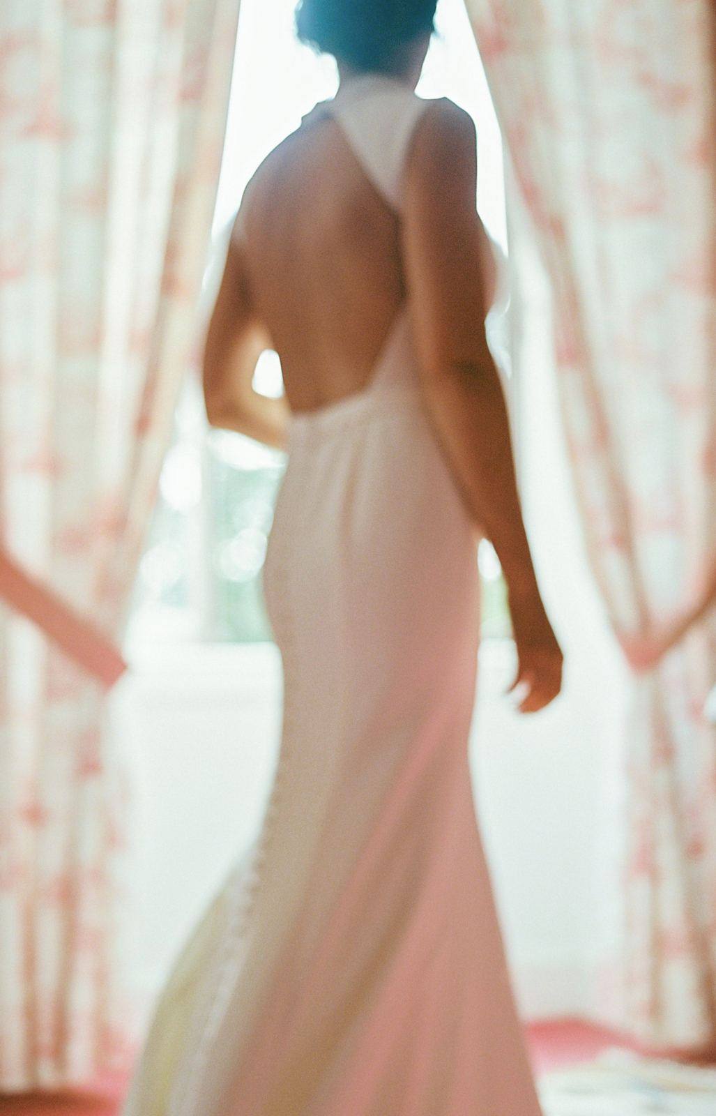 Backlit bride in a backless wedding dress