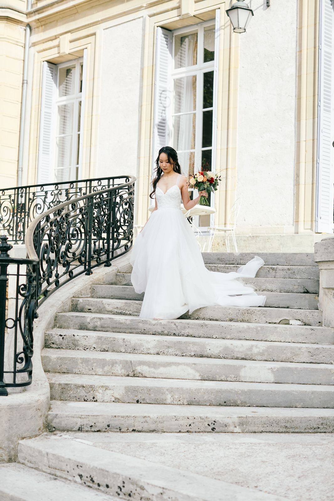 Bride walking down a stone staircase