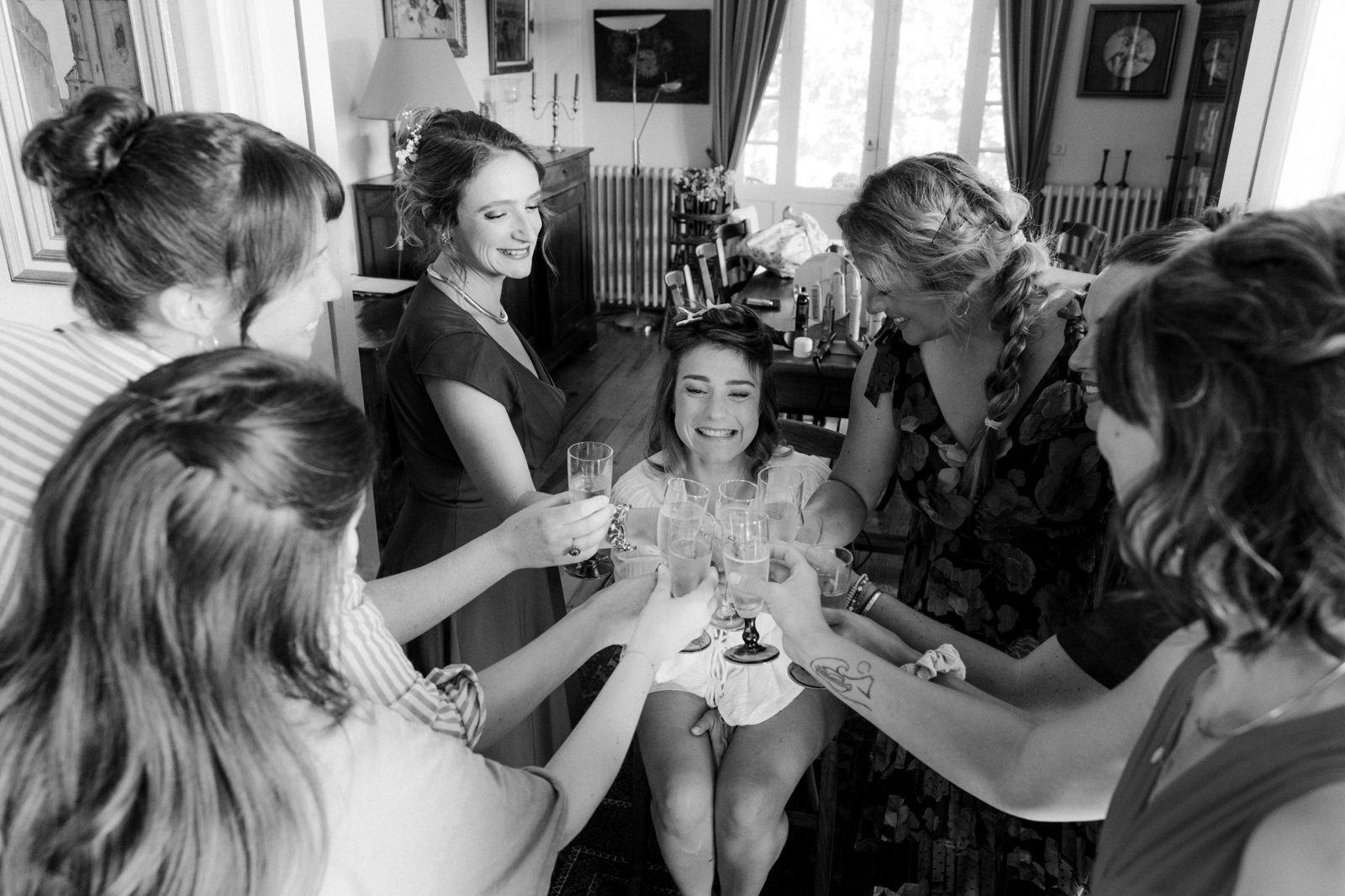 Bridesmaids toasting with champagne before the ceremony