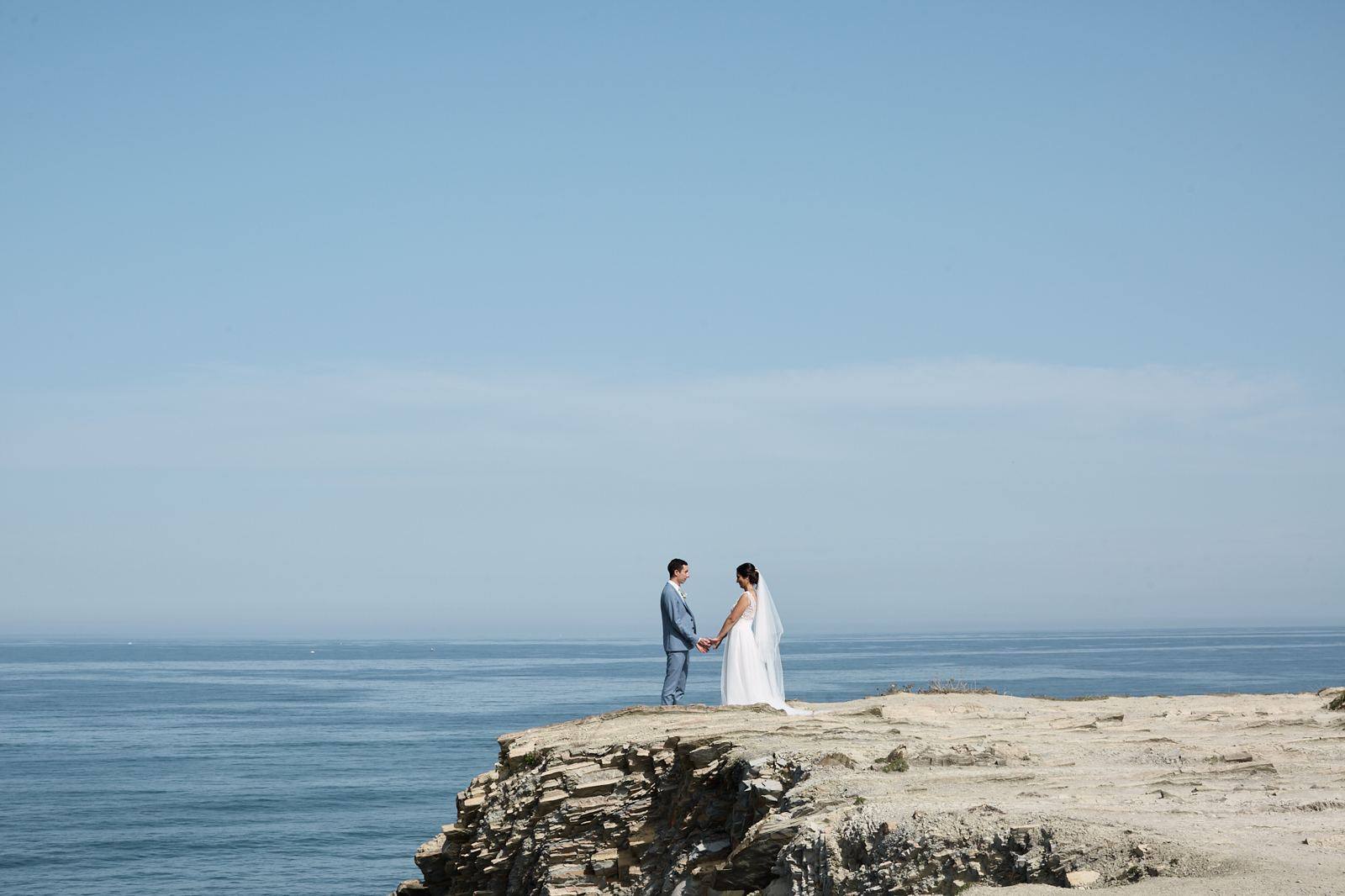 Couple on a clifftop above the sea