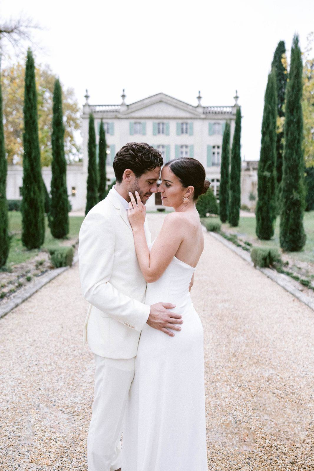 Couple embracing on a tree-lined path