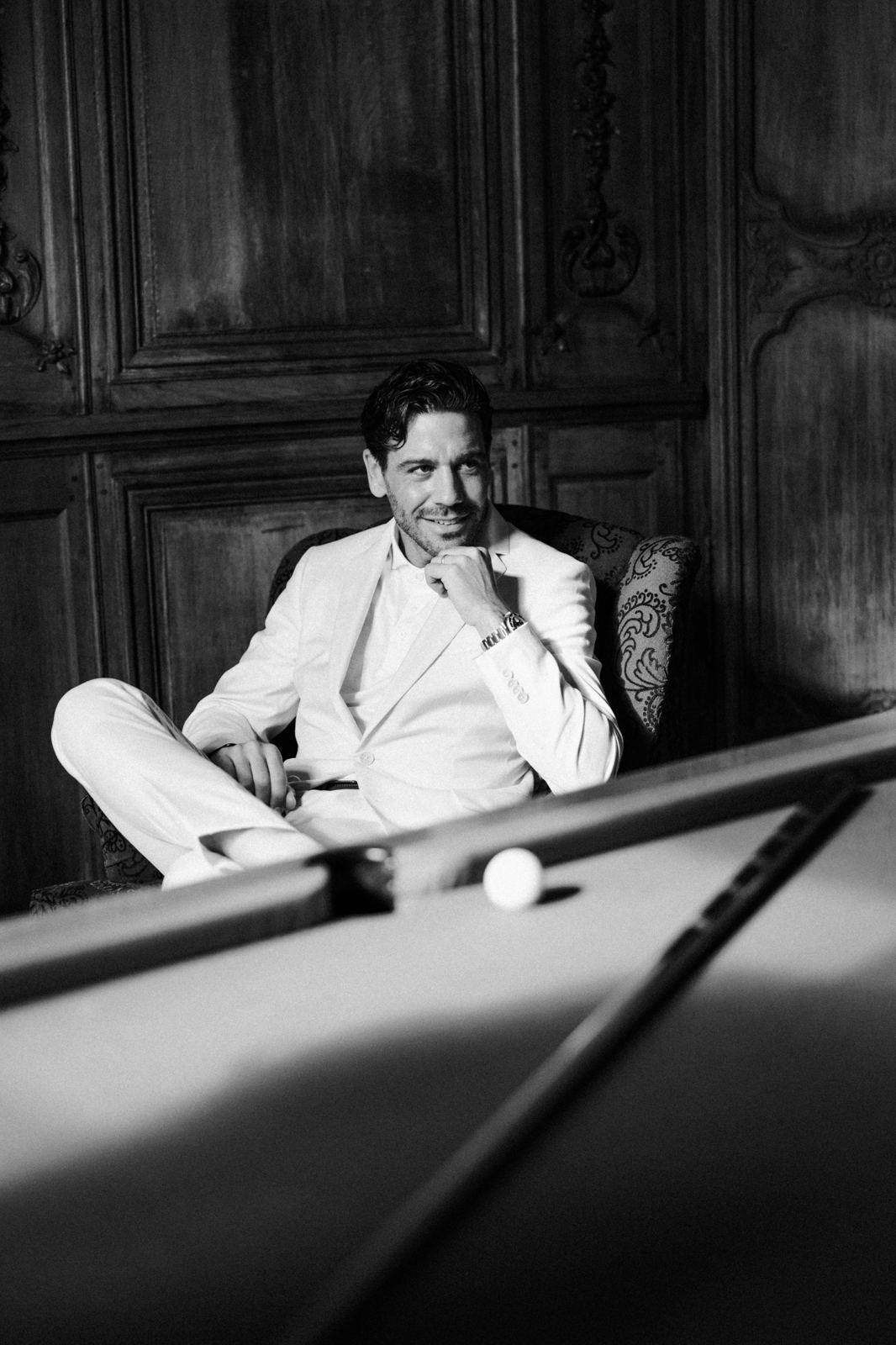 Groom getting ready in a billiard room