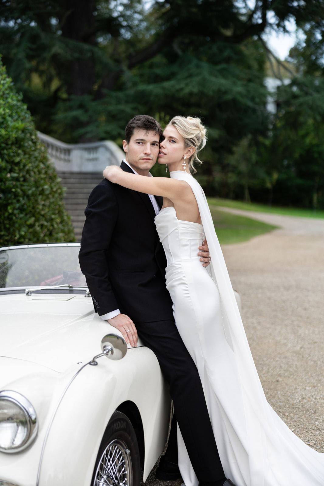 Newlyweds beside a vintage car